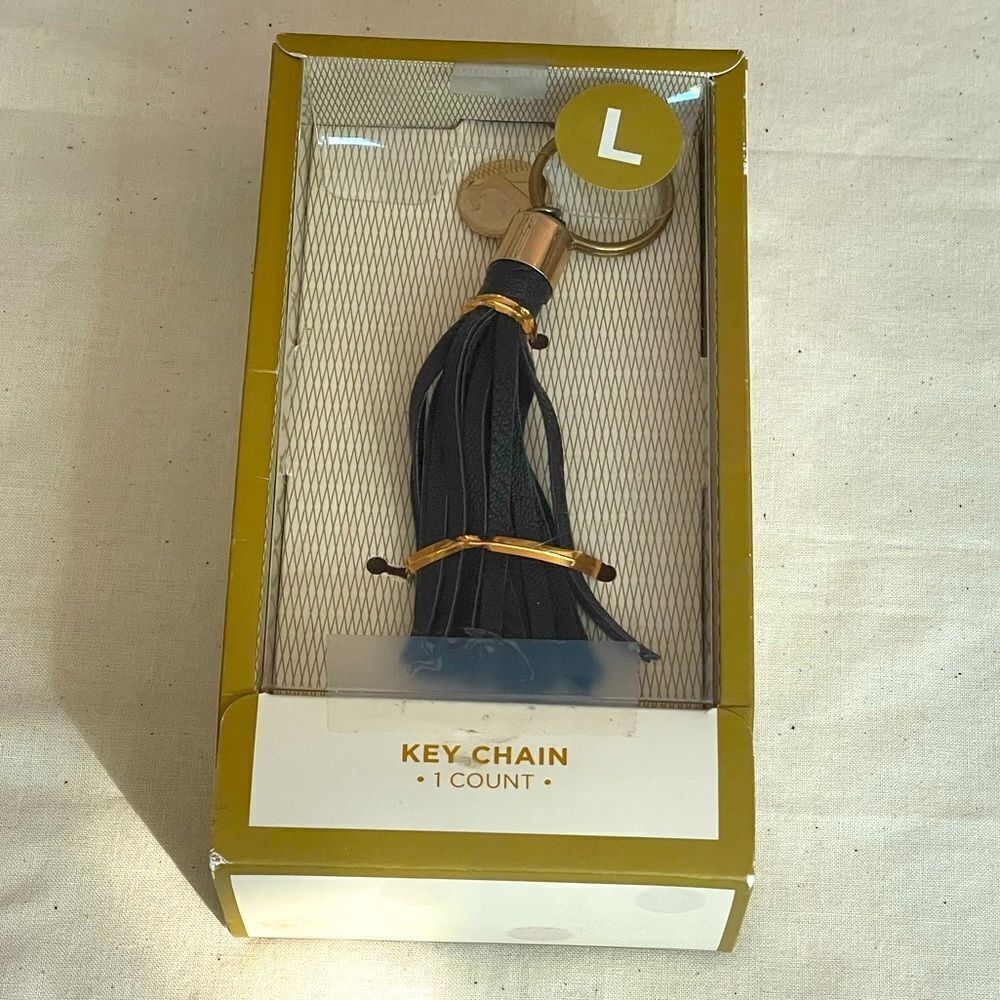 Black leather fringe keychain with gold coin “L” letter initial (NWT)